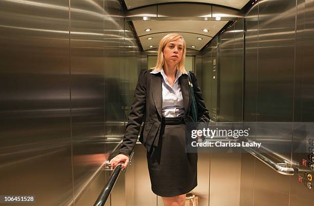 woman standing in lift - elevator inside stock-fotos und bilder