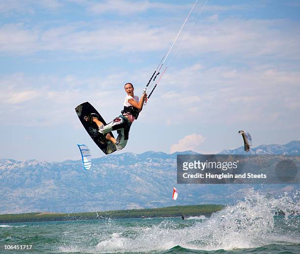 kitesurfer jumping - kite surfing stock pictures, royalty-free photos & images