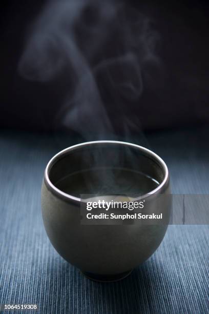 an asian tea bowl with steam pouring out - japanese tea cup stock pictures, royalty-free photos & images