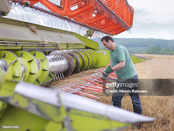 farmer doing maintenance on harvester - agricultural equipment bildbanksfoton och bilder
