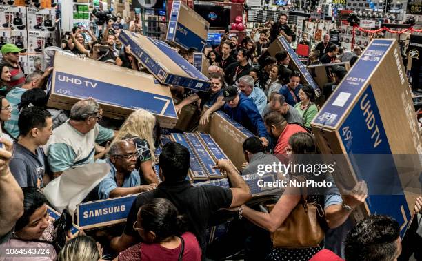 People participate in a "Black Friday" event in São Paulo, Brazil, on November 23, 2018. "Black Friday" is a term created in the...