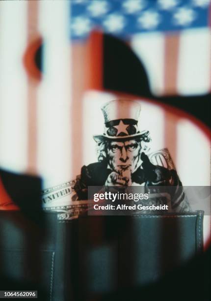 James Montgomery Flagg's Uncle Sam recruitment poster superimposed on a wallet and dollars banknotes, US, 1982.