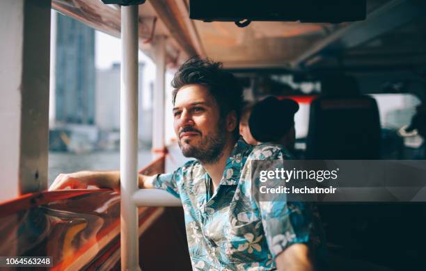 young tourist riding on the bangkok ferry boat - bangkok river stock pictures, royalty-free photos & images