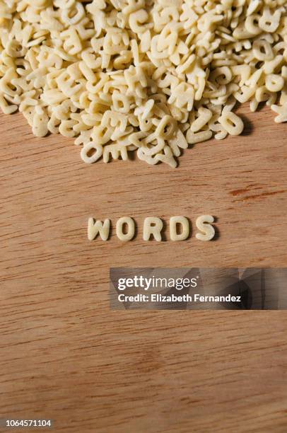 word "words" made of alphabet pasta on wooden table background - jogo de palavras imagens e fotografias de stock