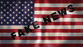 American flag with the words Fake News, ideal footage to sensitize the use of the media in order not to manipulate and misinform people
