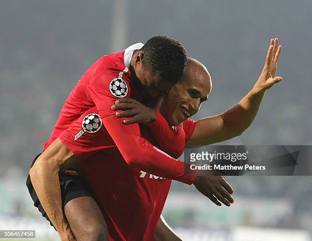 Gabriel Obertan of Manchester United celebrates scoring their second goal with Patrice Evra during the UEFA Champions League Group C match between...