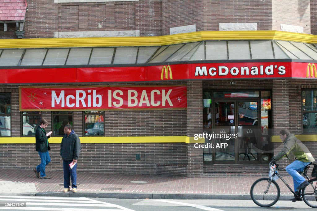 Pedestrians move past a McDonald's resta