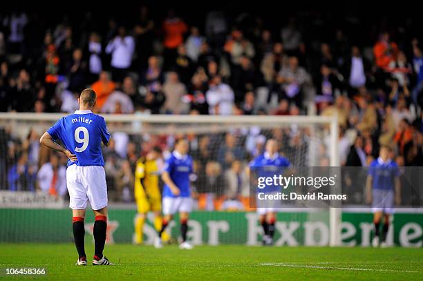 Players of Glasgow Rangers reacts after Ricardo Costa scored the third goal of Valencia CF during their UEFA Champions League group C match between...