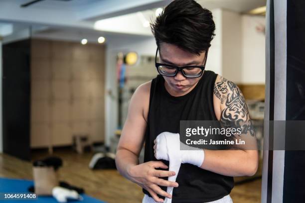 Woman boxer wrapping hands