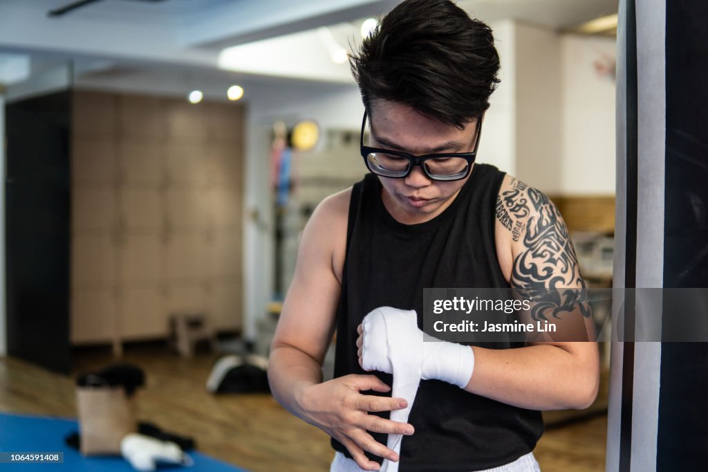 Woman boxer wrapping hands