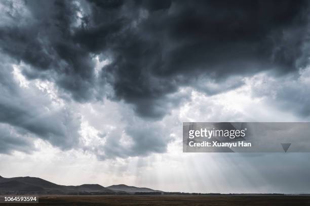 rays of light through storm clouds - prairie stock pictures, royalty-free photos & images
