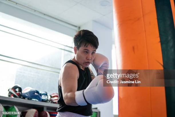 Strong woman boxer and punching bag
