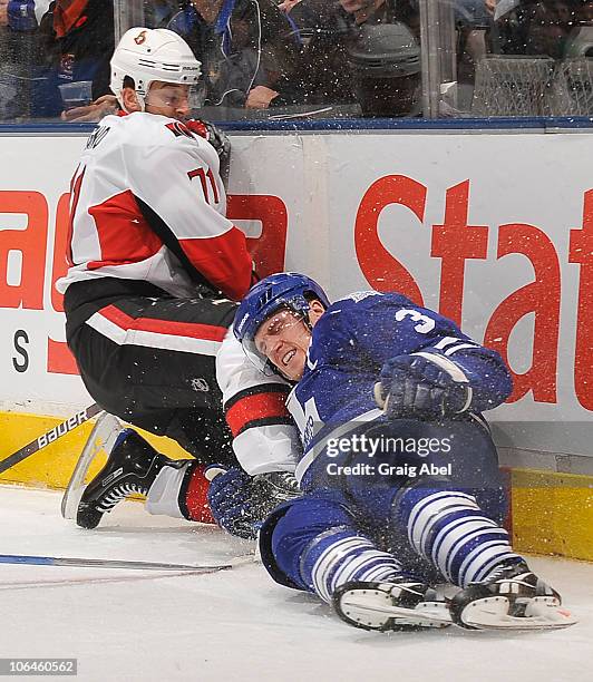 Nick Foligno of the Ottawa Senators and Dion Phaneuf of the Toronto Maple Leafs crash into the end boards during game action November 2, 2010 at the...