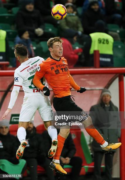 Maciej Rybus of FC Lokomotiv Moscow vies for the ball with Vladimir Ilyin of FC Ural Ekaterinburg during the Russian Premier League match between FC...