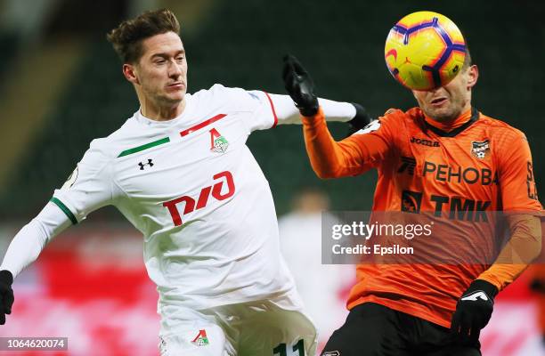 Anton Miranchuk of FC Lokomotiv Moscow vies for the ball with Yury Bavin of FC Ural Ekaterinburg during the Russian Premier League match between FC...