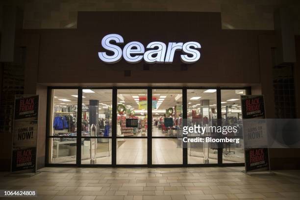 Entrance doors stand locked before opening hours at a Sears Holdings Corp. Store on Black Friday at the Newport Centre Mall in Jersey City, New...