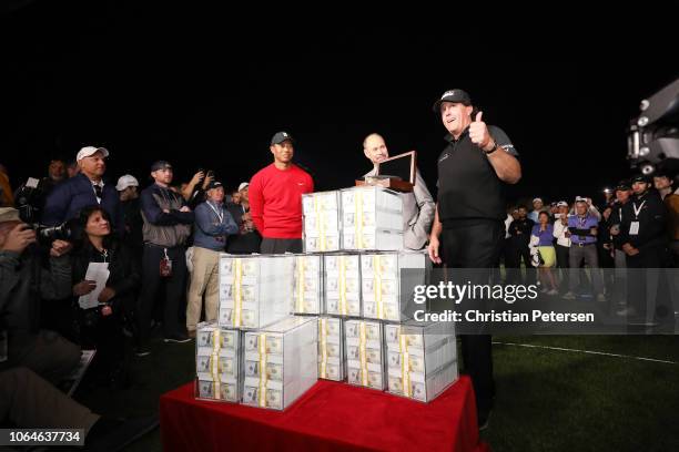 Phil Mickelson celebrates with the winnings after defeating Tiger Woods as Ernie Johnson looks on during The Match: Tiger vs Phil at Shadow Creek...