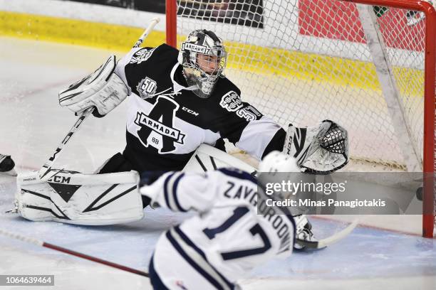 Dmitry Zavgorodniy of the Rimouski Oceanic scores a goal in the second period on goaltender Emile Samson of the Blainville-Boisbriand Armada during...