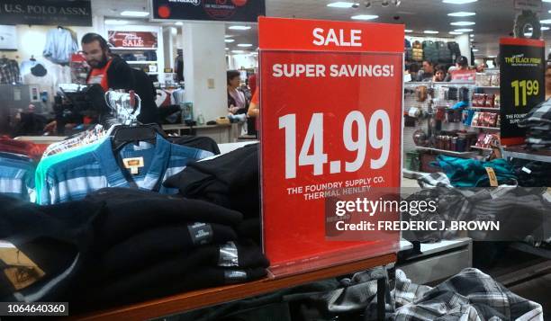 People shop for clothing items on sale for Black Friday at a branch of JC Penny's in Montebello, California, on November 23, 2018. - While the...