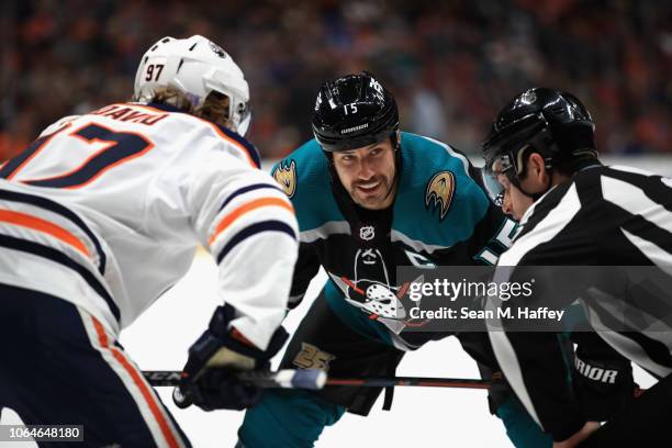 Connor McDavid of the Edmonton Oilers and Ryan Getzlaf of the Anaheim Ducks talk during a faceoff during the first period of a game at Honda Center...