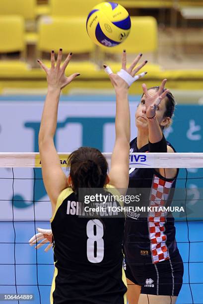 Mia Jerkov of Croatia pushes the ball above Kazakhstan's setter Korinna Ishimtseva during their final Pool C preliminary round match at the FIVB 2010...