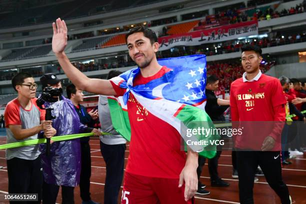 Odil Ahmedov of Shanghai SIPG celebrates with teammates during the award ceremony of the 2018 Chinese Super League 29th round match between Shanghai...