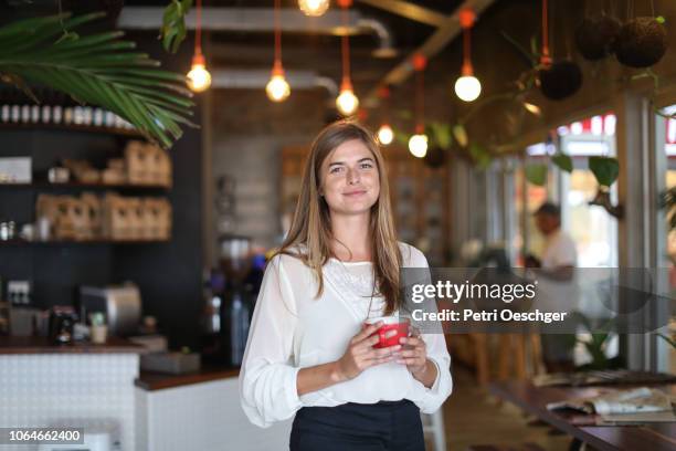 a young woman working in a cafe. - chef restaurant stock-fotos und bilder