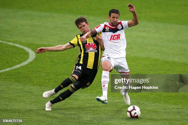 Alex Rufer of the Phoenix and Vince Lia of Adelaide United compete for the ball during the round five A-League match between the Wellington Phoenix...