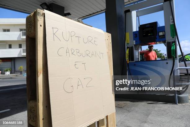 Sign reads "shortage of oil and gas" in a pump station as Yellow vests protesters gather on November 24, 2018 in front of the Prefecture in...