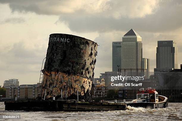 Replica of the upper section of the fourth funnel of the Titanic is towed along the river Thames towards Canary Wharf on November 3, 2010 in London,...