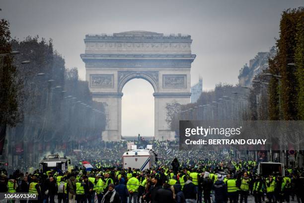 Protestors gather on the Champs Elysees, in Paris on November 24, 2018 during a national rally called the Yellow vests to protest against rising oil...