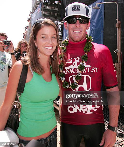 Andy Irons celebrates with girlfirend, Lyndie Dupuis, after winning the Men's finals of the U.S. Open of Surfing in Huntington Beach, Calif., Sunday,...