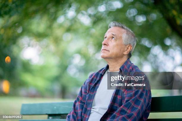 lonely man - park bench stock pictures, royalty-free photos & images