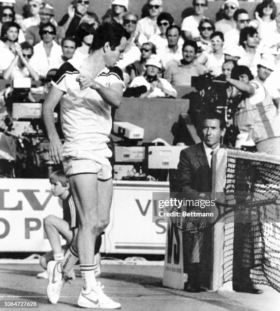 John McEnroe of USA throws his racket at the net as he loses a point against Ivan Lendl of Czechoslovakia during their French Open tennis final...