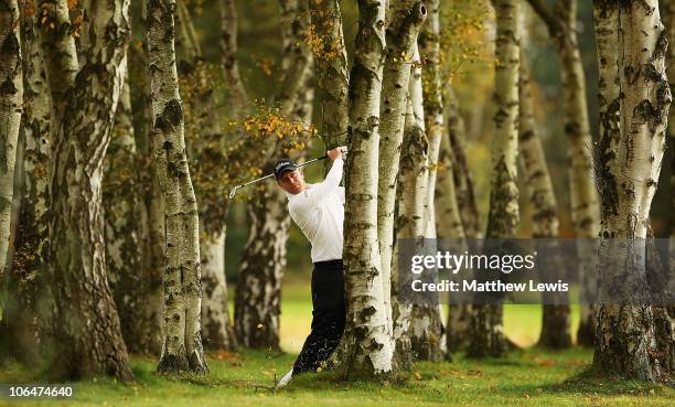 John Wells of Cherry Burton plays from behind the trees on the 8th hole during the first day of the Srixon PGA Playoff Final at Little Aston Golf...