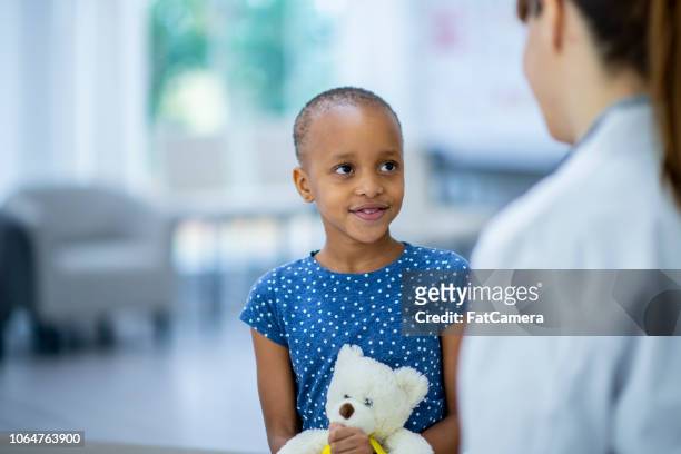 patient talking with doctor - bald girl stock pictures, royalty-free photos & images