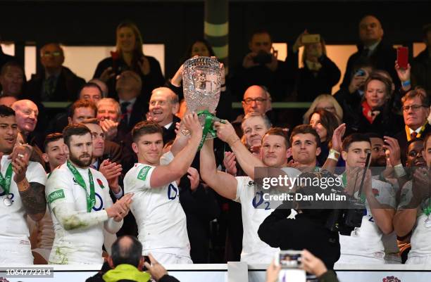 Owen Farrell of England and Dylan Hartley of England lift the Cook Cup after the Quilter International match between England and Australia at...