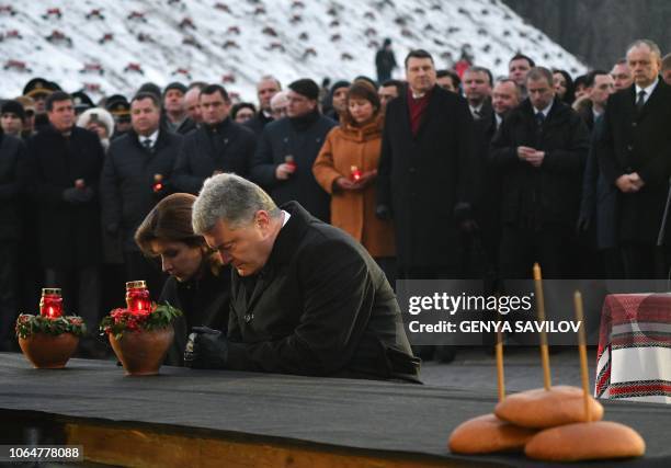 Ukrainian President Petro Poroshenko and his wife Maryna Poroshenko pay their respects as they take part in a commemoration ceremony at a monument to...