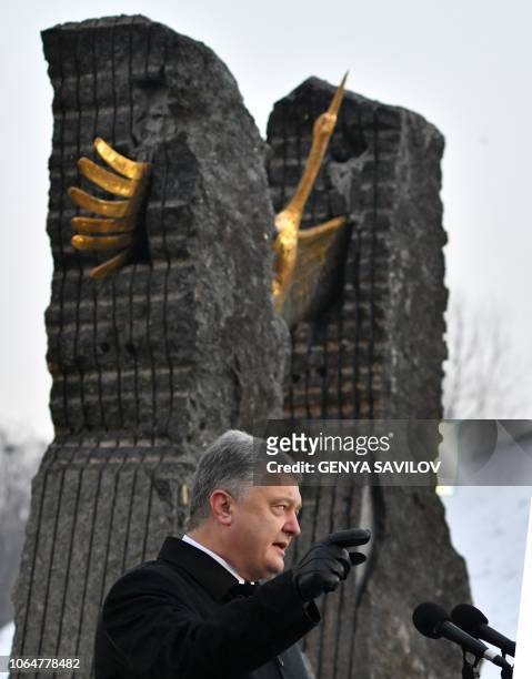 Ukrainian President Petro Poroshenko addresses to audience during a commemoration ceremony at a monument to victims of the Holodomor famine of...