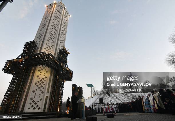 Ukrainian President Petro Poroshenko addresses to audience during a commemoration ceremony at a monument to victims of the Holodomor famine of...