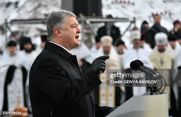 Ukrainian President Petro Poroshenko addresses to audience during a commemoration ceremony at a monument to victims of the Holodomor famine of...