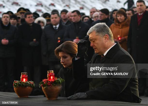 Ukrainian President Petro Poroshenko and his wife Maryna Poroshenko pay their respects as they take part in a commemoration ceremony at a monument to...