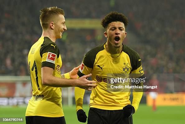 Jadon Sancho of Borussia Dortmund reacts with team mate Marco Reus of ...