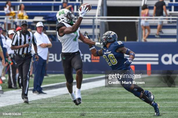 Obi Obialo of the Marshall Thundering Herd makes a catch in the first half against the FIU Golden Panthers at Ricardo Silva Stadium on November 24,...