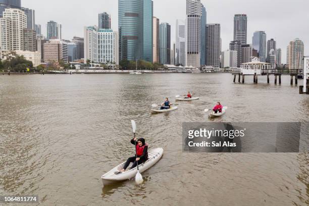 group of people kayaking on the brisbane river - kayaking australia stock pictures, royalty-free photos & images