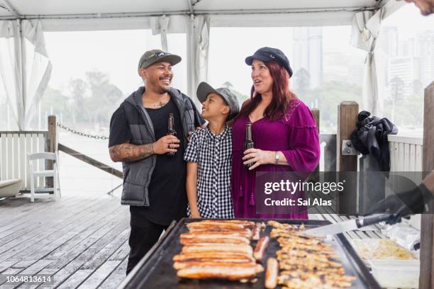 family and friends enjoying a barbecue - australian bbq stock pictures, royalty-free photos & images