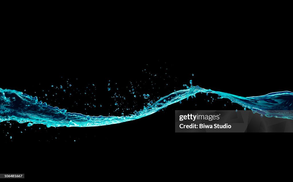 Fluorescent blue water splash black background