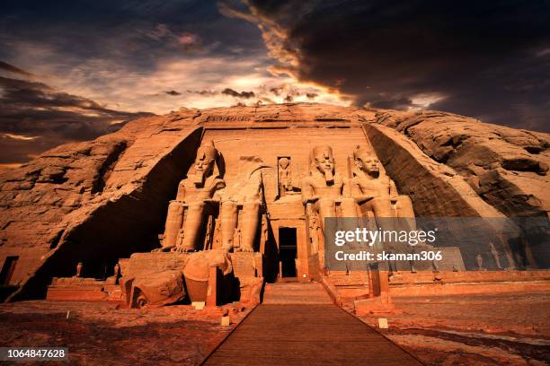 beautiful ruins seated statues of ramesses ii at the great temple of abu simbel. - egyptian tomb stock-fotos und bilder