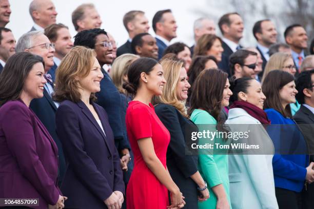 Members-elect including Alexandria Ocasio-Cortez, D-N.Y., in red, pose for the freshman class photo on the East Front of the Capitol on November 14,...