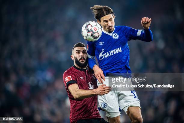 Benjamin Stambouli of Schalke battles for possession with Mikael Ishak of Nuernberg during the Bundesliga match between FC Schalke 04 and 1. FC...